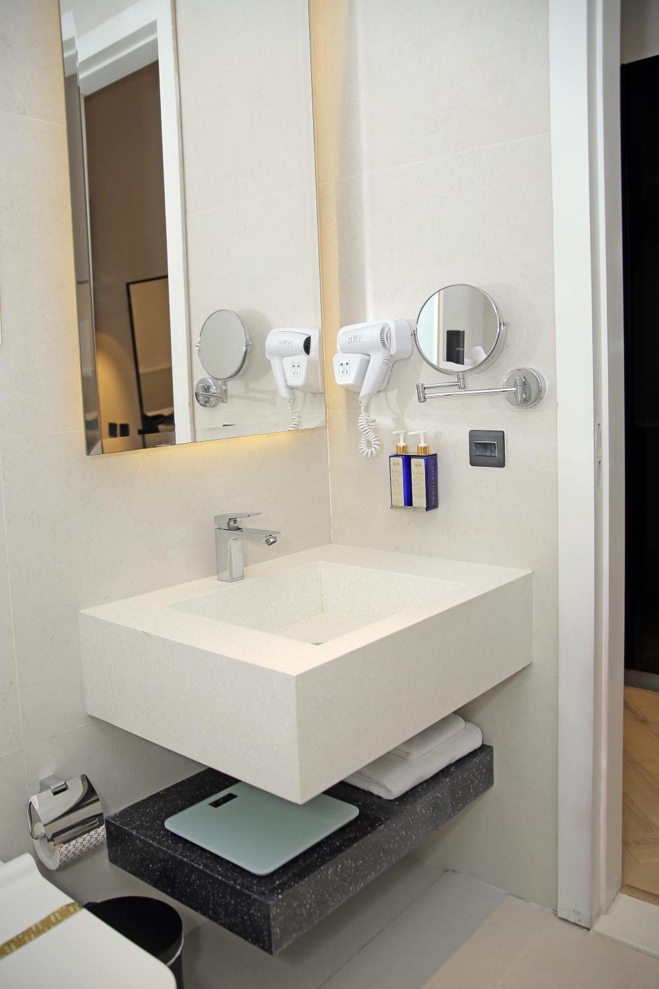 Ambiance Boutique Art Hotel Лахор Номер фото A wall mounted hair dryer in a hotel bathroom